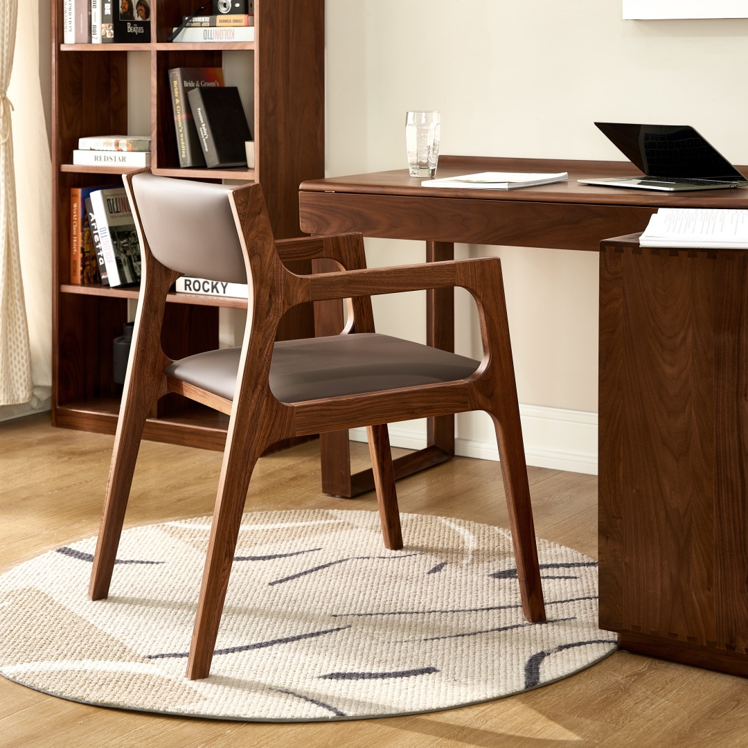 Kaede walnut armchair with a taupe leather seat beside a solid walnut desk